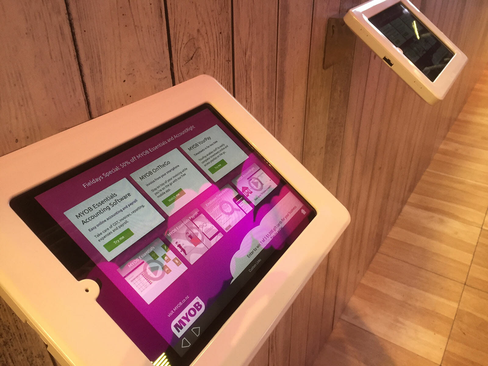 MYOB conference booth with kiosk app in use